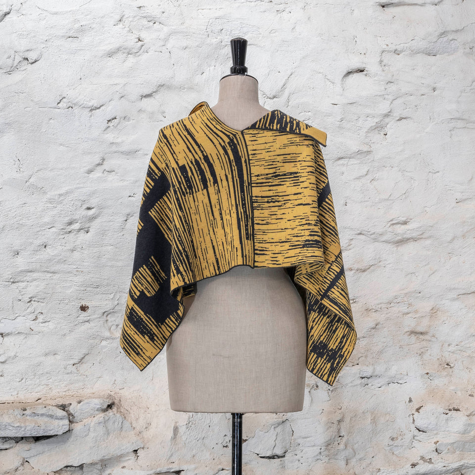 knitted inklines cape. graphic, linear, abstract pattern. Show in yellow with dark grey colourway