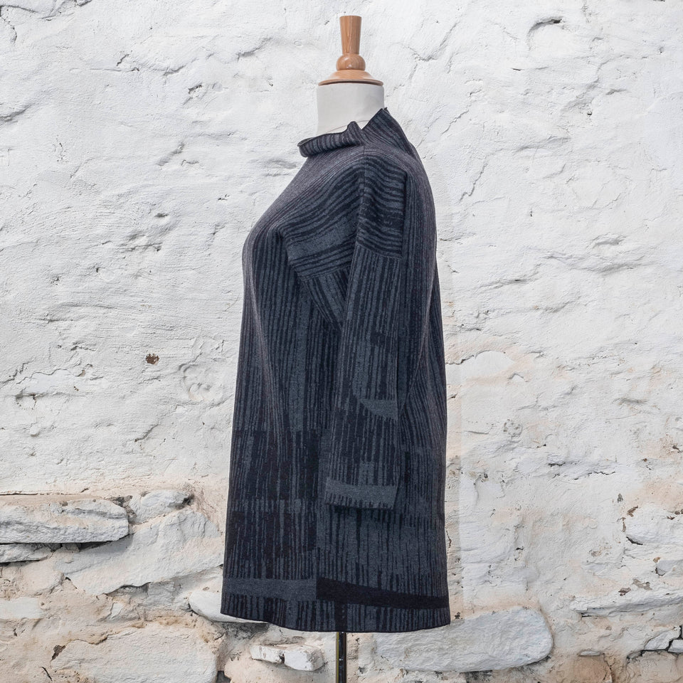 knitted inklines tunic, a straight cut longline jumper with stand-up neck. Linear, abstract design. Here shown in colourway midnight greys