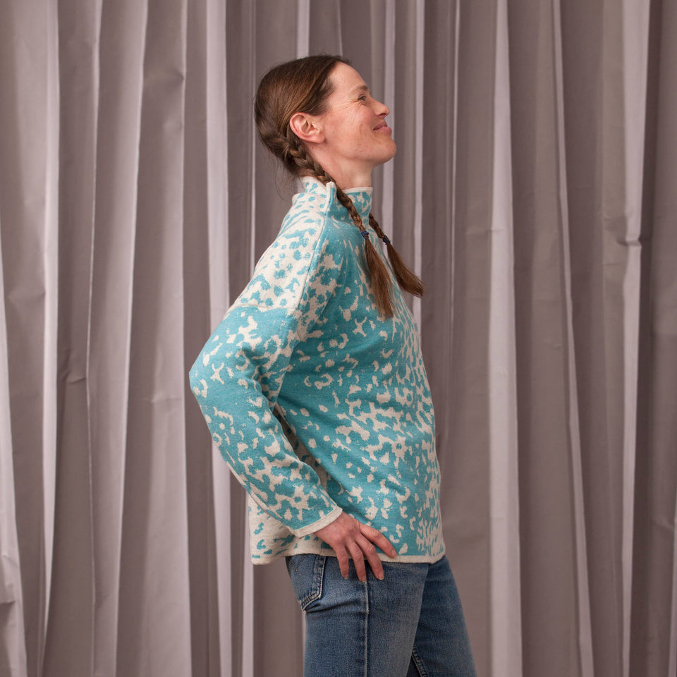 Knitted marlet jumper. Mottled animal print abstract pattern shown in turquoise and white