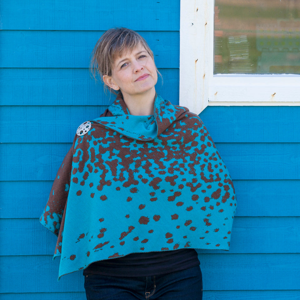 Knitted marlet wrap. Mottled animal print design showin in aqua and bronze