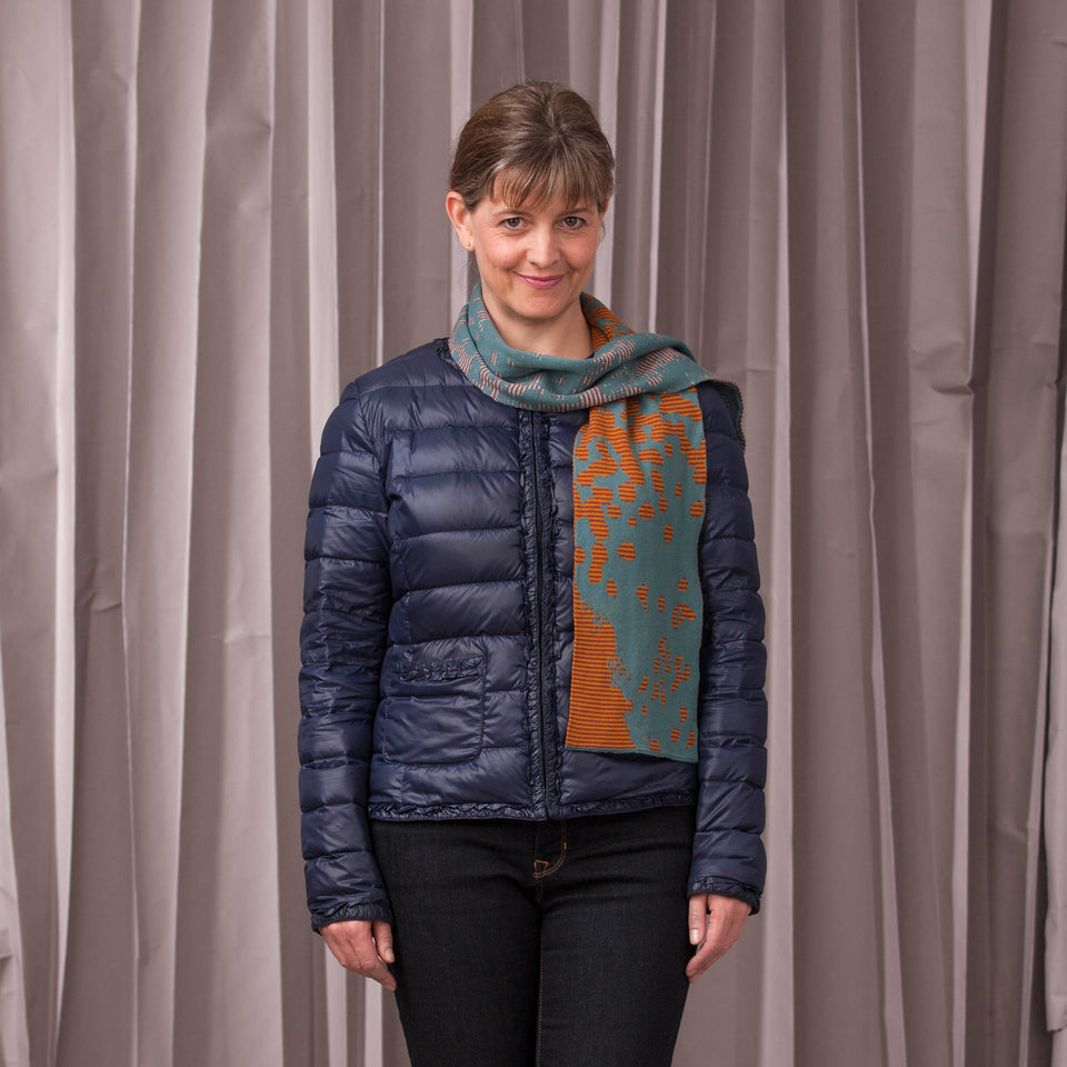 marlet scarves. mottled abstract pattern broken up by thin stripes. shown in turquoise mix
