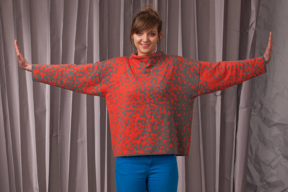 Knitted marlet jumper. Mottled animal print abstract pattern shown in coral and mid grey