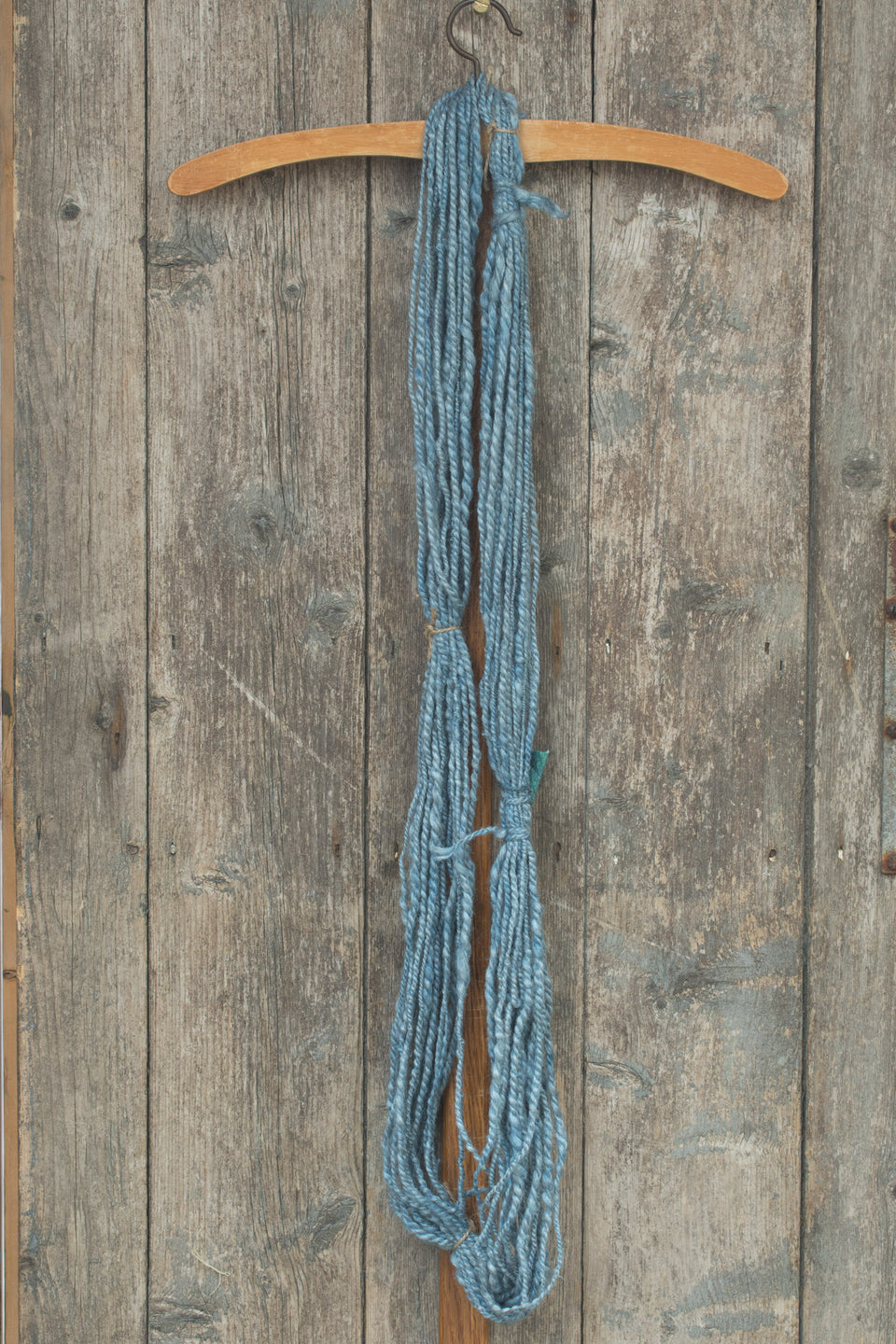 silvery pale indigo handspun yarn, in silk and angora. shown in a hank