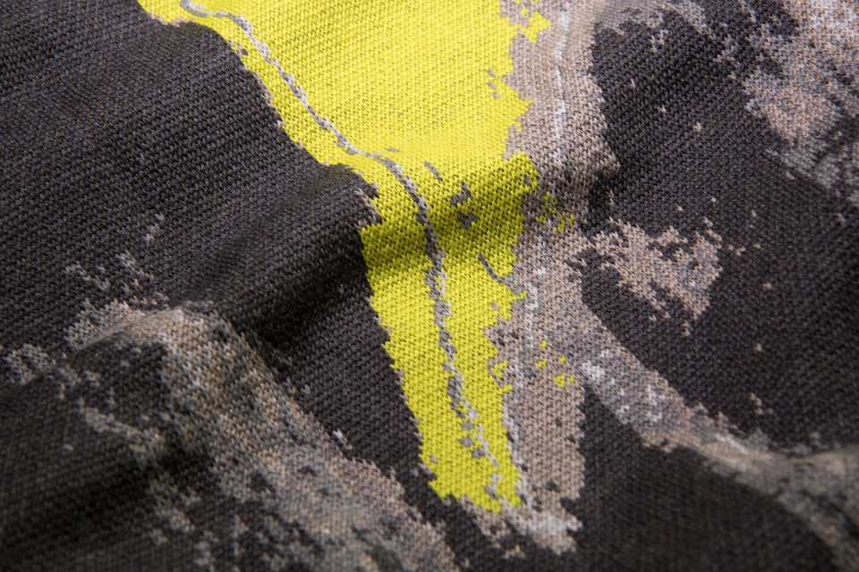 closeup up finely knitted Hoswick Paint jumper - abstract pattern in shaded greys with fluoro yellow highlights