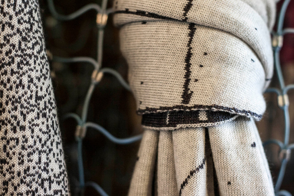 Knitted Byre cravat. Abstract, graphic design in an asymmetric shape. Shown in Charcoal and stone white. Detail.