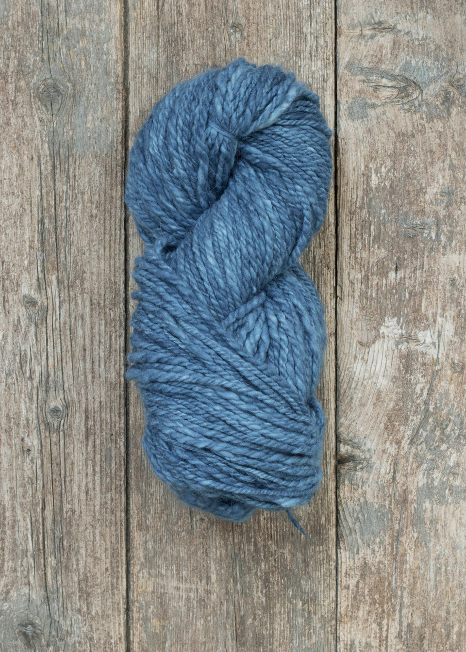 handspun yarn, hand-dyed in natural indigo. merino and cashmere. shown wound into a skein