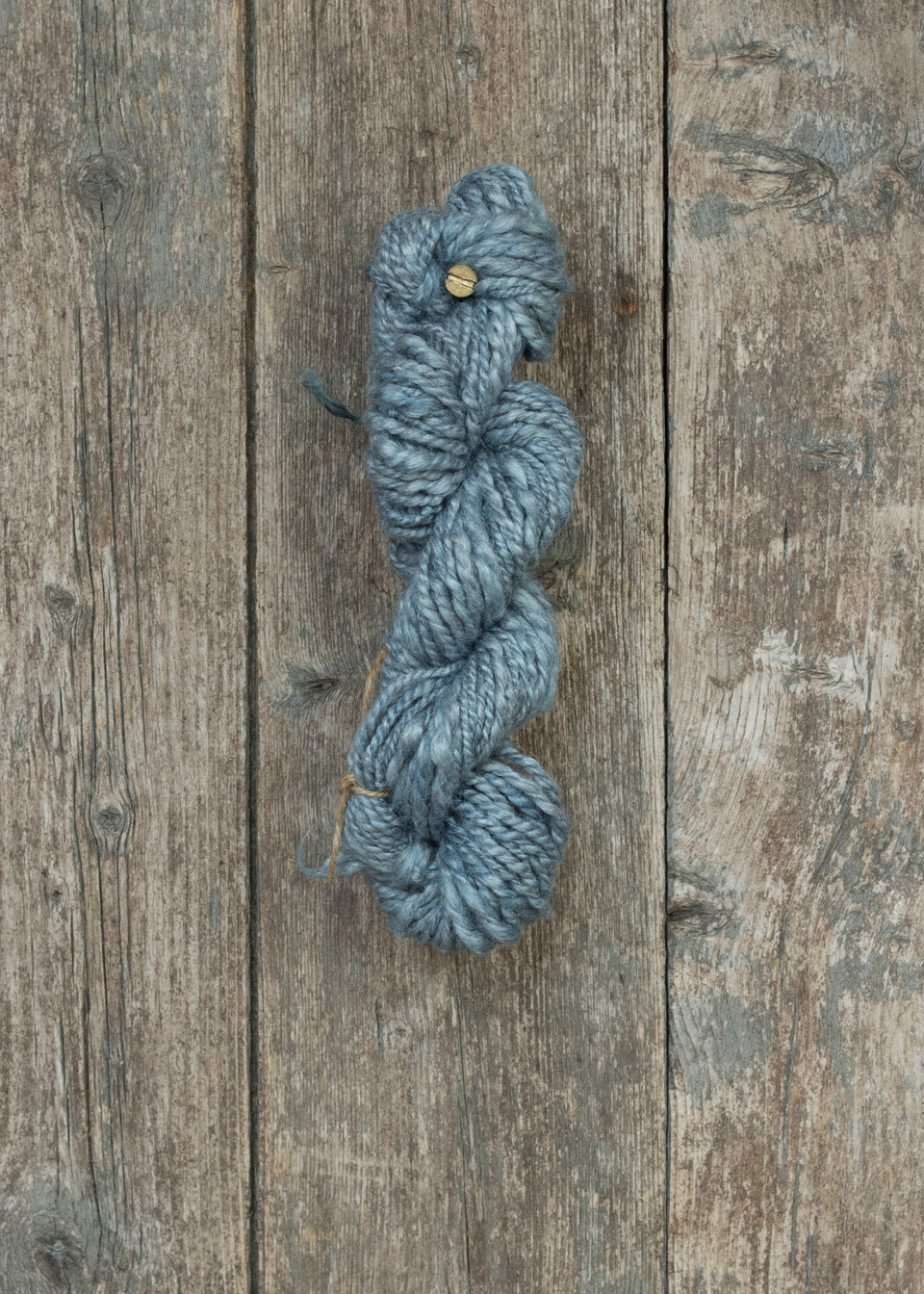 silvery pale indigo handspun yarn, in silk and angora. shown wound in a skein